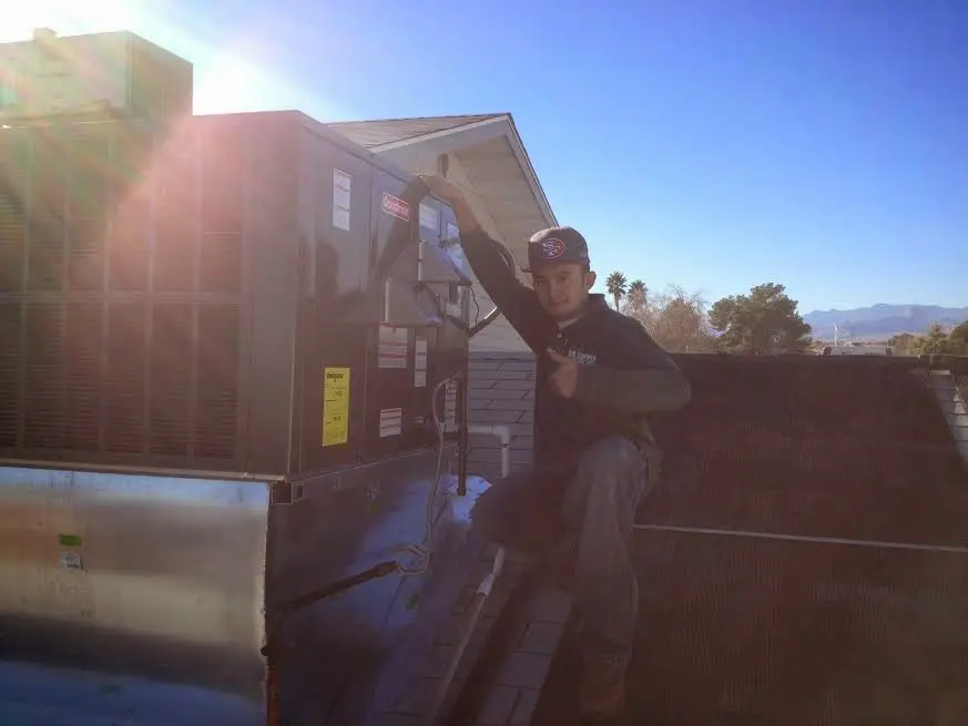 HVAC technician performing HVAC Inspection on a rooftop unit in Laurel Hill